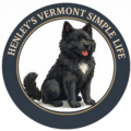 Henley the dog, a black Chow and Newfoundland mix, sitting inside a circular logo for Henley's Vermont Simple Life.